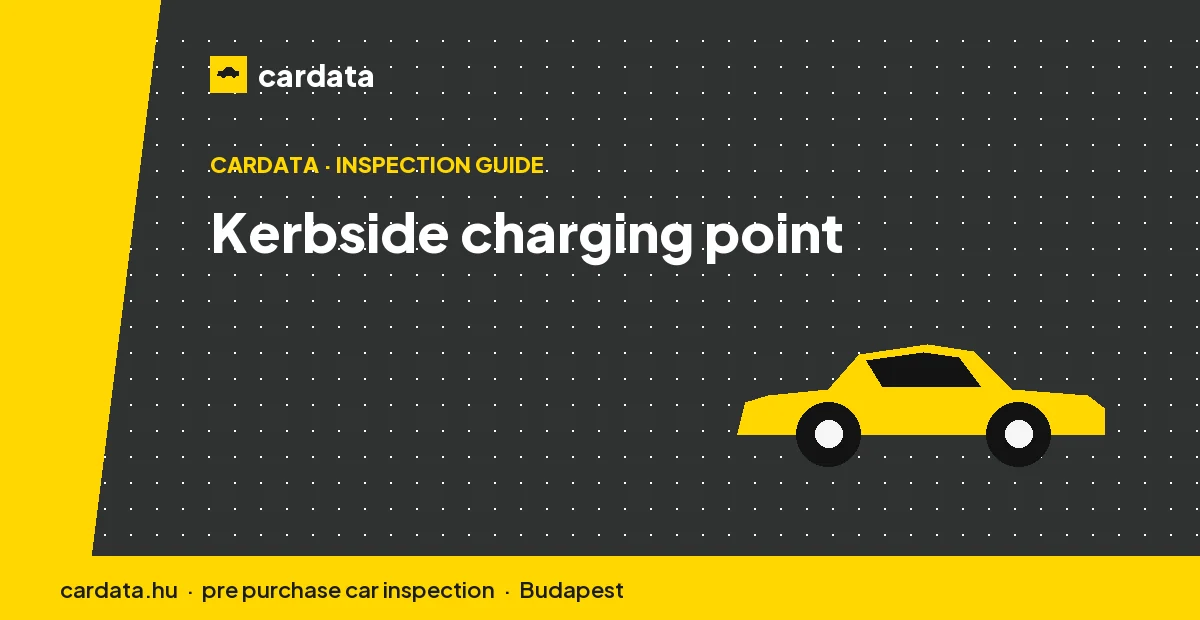 A driver plugs a used electric car into a public kerbside charging point on a Budapest street at dusk.
